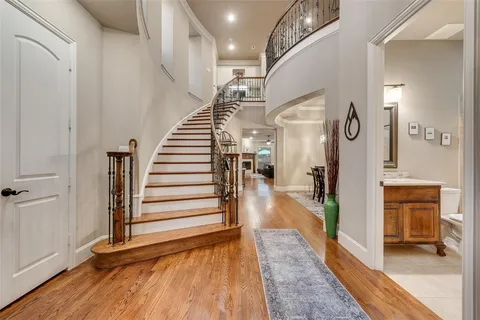 a view of a hallway view with wooden floor and staircase