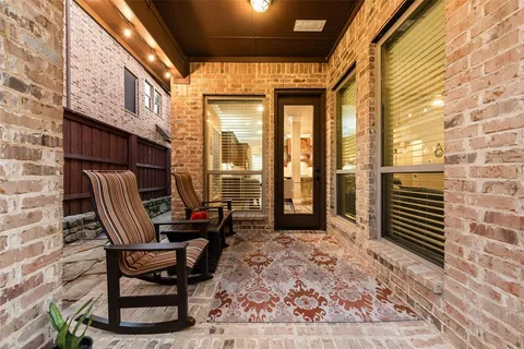 a view of a patio with a table and chairs