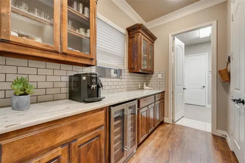 a kitchen with stainless steel appliances granite countertop a sink and wooden cabinets