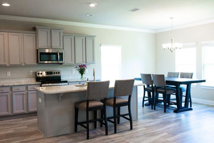 271 Wayne Trail Santa Rosa Beach, FL 32459 - Photo 17 of 42 a kitchen with a dining table chairs and a refrigerator