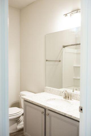 271 Wayne Trail Santa Rosa Beach, FL 32459 - Photo 33 of 42 a bathroom with a granite countertop sink a toilet and a mirror