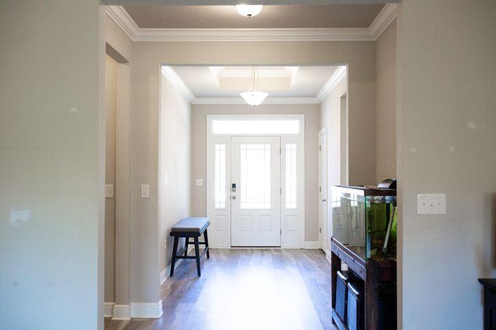 271 Wayne Trail Santa Rosa Beach, FL 32459 - Photo 5 of 42 a view of a hallway with wooden floor and staircase