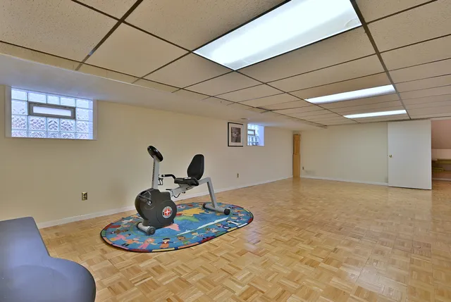 a kitchen with a sink and a wooden floor