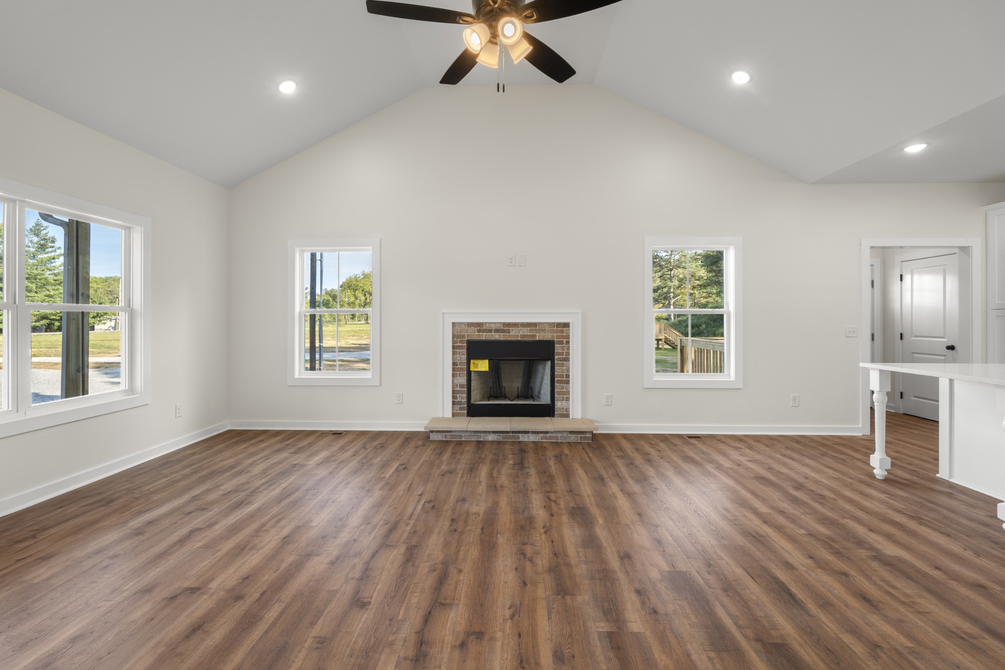 1572 Gilliam Hollow Road Dickson, TN 37055 - Photo 14 of 16 an empty room with wooden floor fireplace and windows