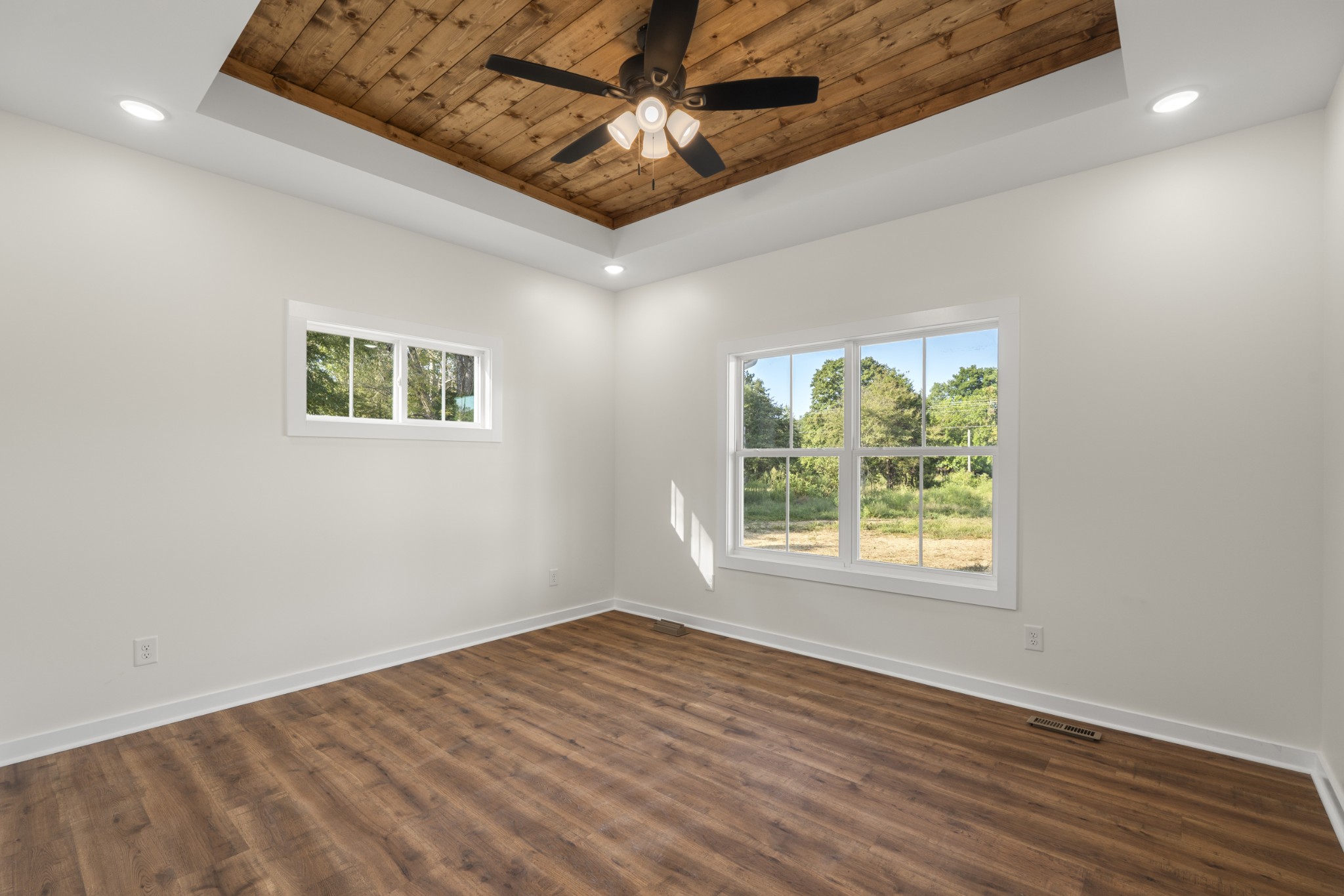 1572 Gilliam Hollow Road Dickson, TN 37055 - Photo 7 of 16 an empty room with wooden floor chandelier fan and windows