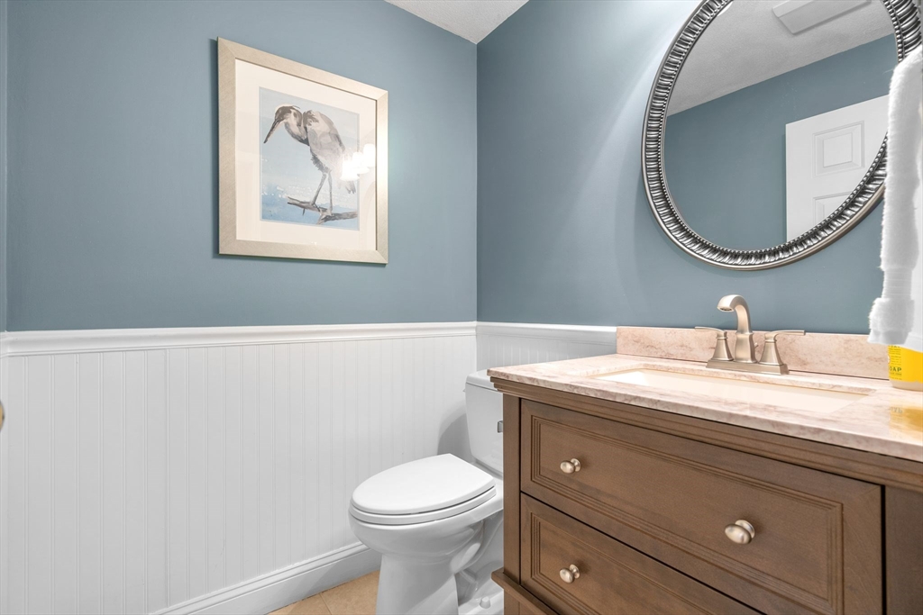 14 Hunters Road Boxford, MA 01921 - Photo 12 of 42 a bathroom with a granite countertop toilet a sink and a mirror