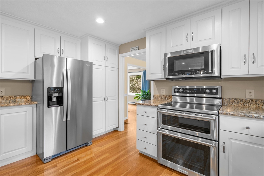 14 Hunters Road Boxford, MA 01921 - Photo 14 of 42 a kitchen with granite countertop a refrigerator stove and microwave