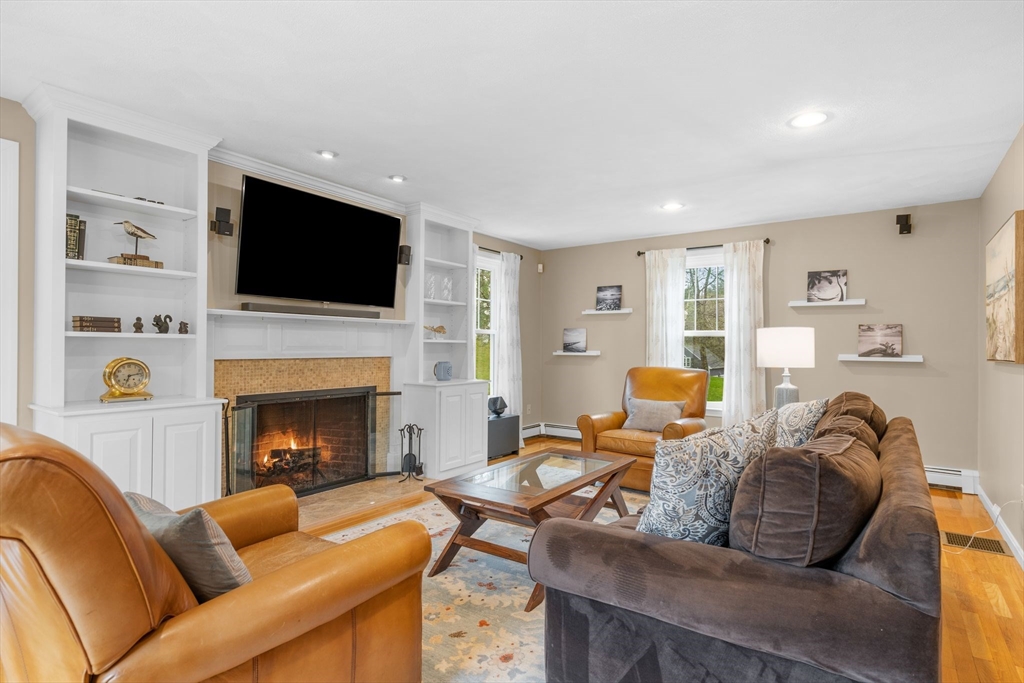 14 Hunters Road Boxford, MA 01921 - Photo 18 of 42 a living room with furniture a flat screen tv and a fireplace