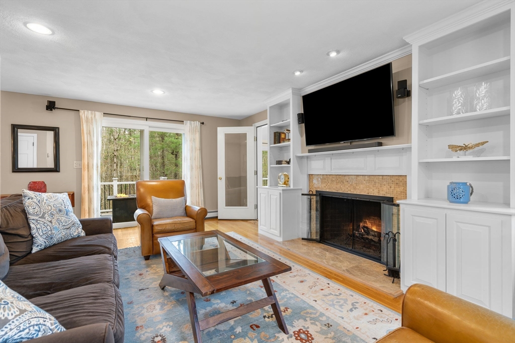 14 Hunters Road Boxford, MA 01921 - Photo 20 of 42 a living room with furniture a flat screen tv and a fireplace