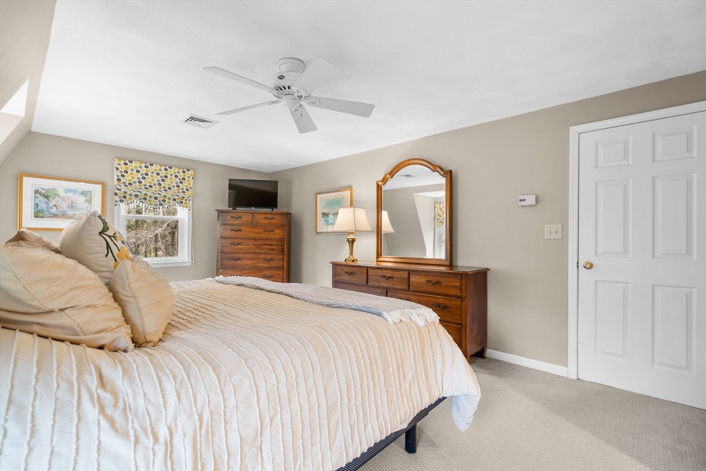 14 Hunters Road Boxford, MA 01921 - Photo 26 of 42 a bedroom with a large bed and a chandelier
