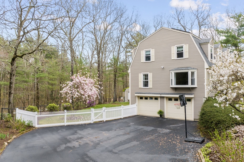 14 Hunters Road Boxford, MA 01921 - Photo 40 of 42 a front view of a house with a yard and garage