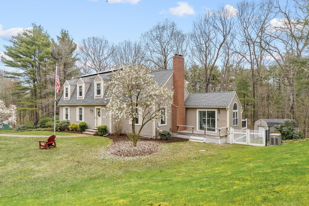 14 Hunters Road Boxford, MA 01921 - Photo 6 of 42 a front view of a house with a yard table and chairs