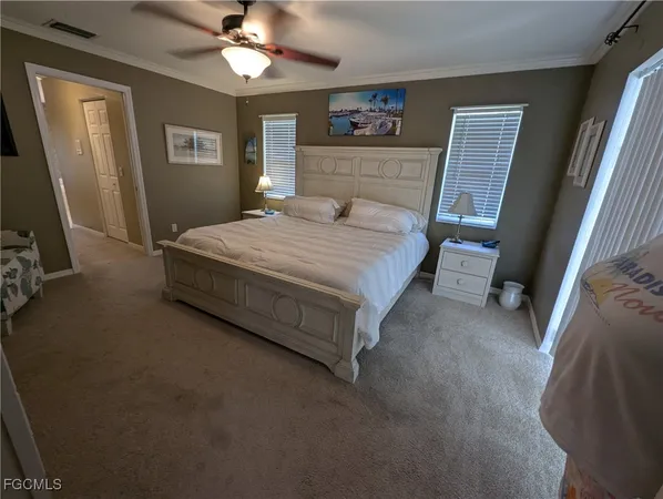 a spacious bedroom with a bed and a chandelier