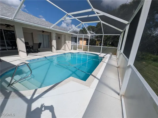 a view of swimming pool with outdoor seating