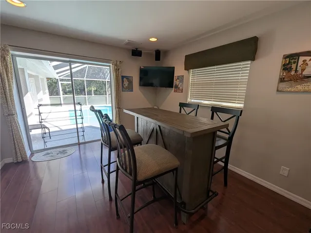 a dining room with furniture and wooden floor