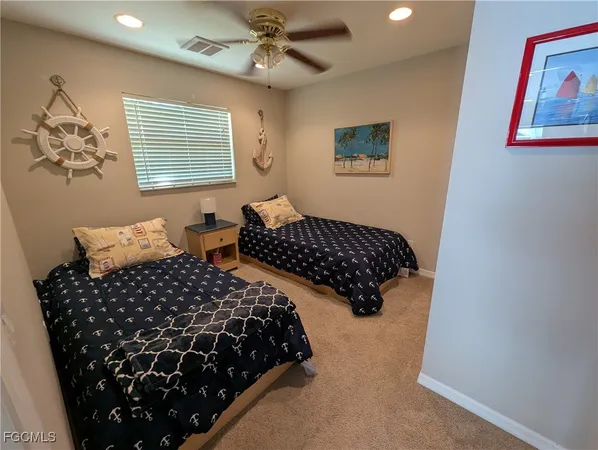 a bedroom with bed lamp and a window