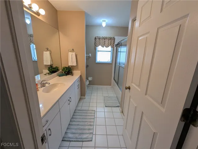 a bathroom with a sink a mirror and a shower