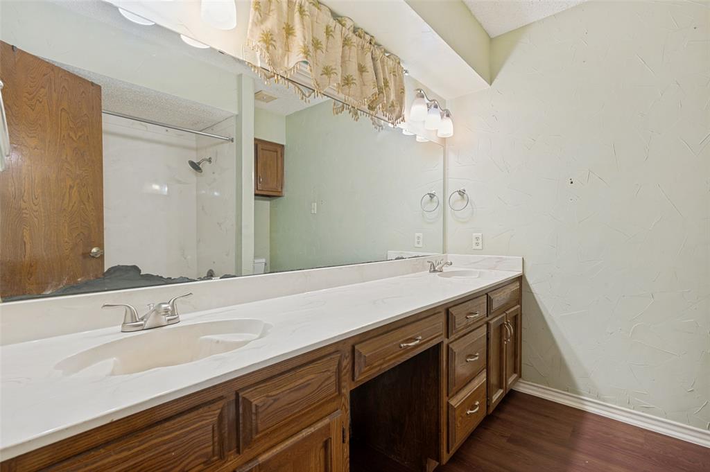 508 South Pedigo Street Pilot Point, TX 76258 - Photo 19 of 26 Dual vanity with wood-finish cabinetry and integrated sinks