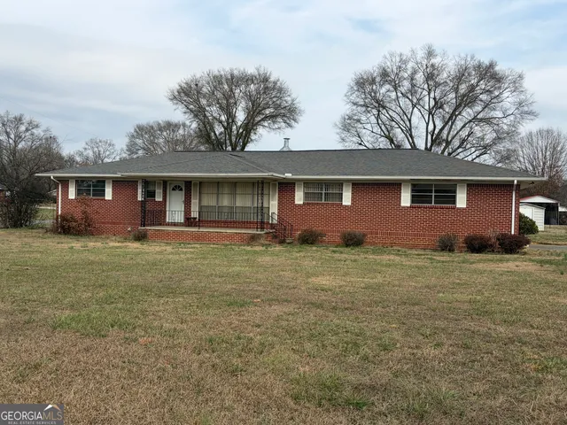 a front view of house with yard and green space