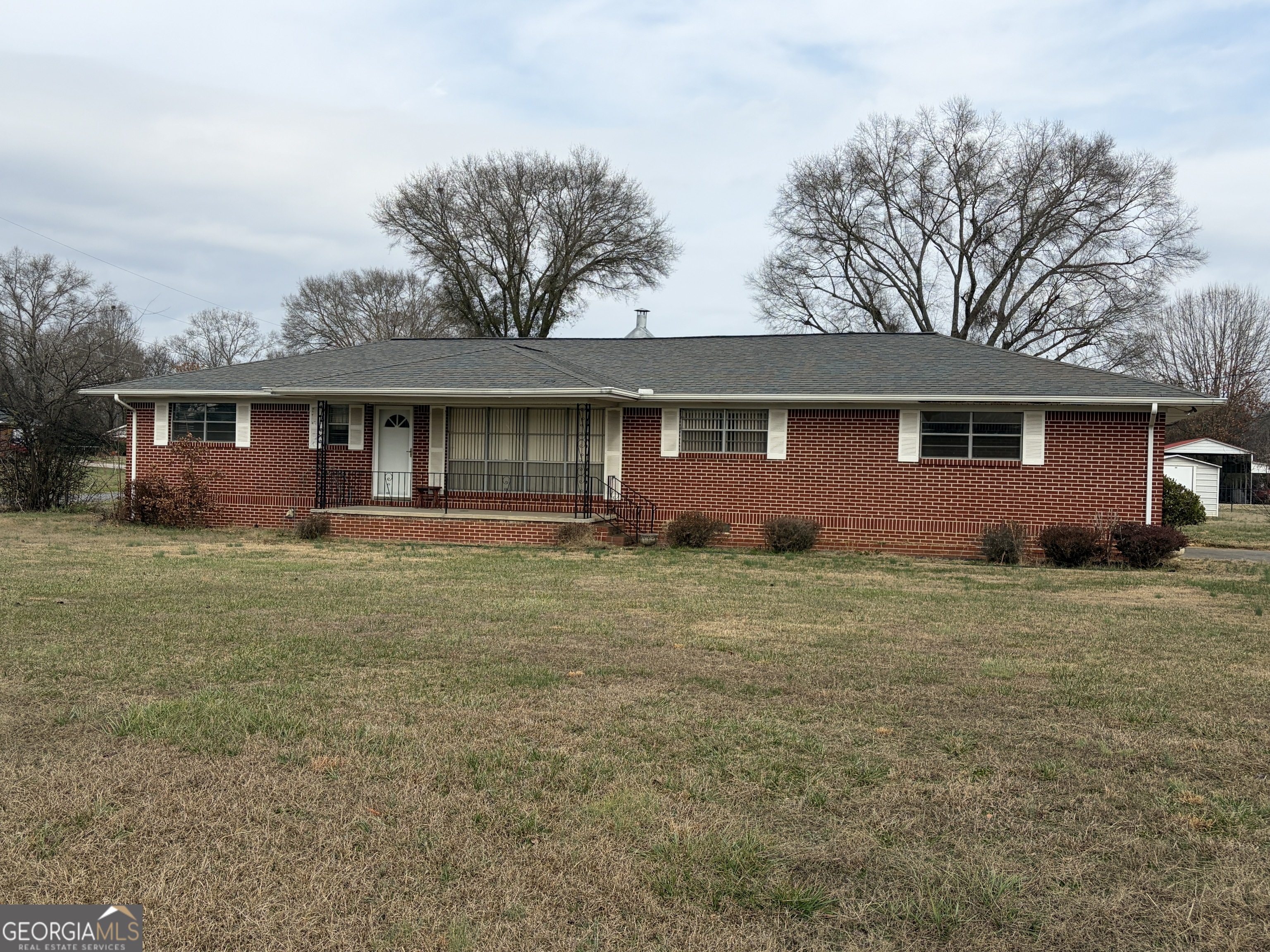 a front view of house with yard and green space