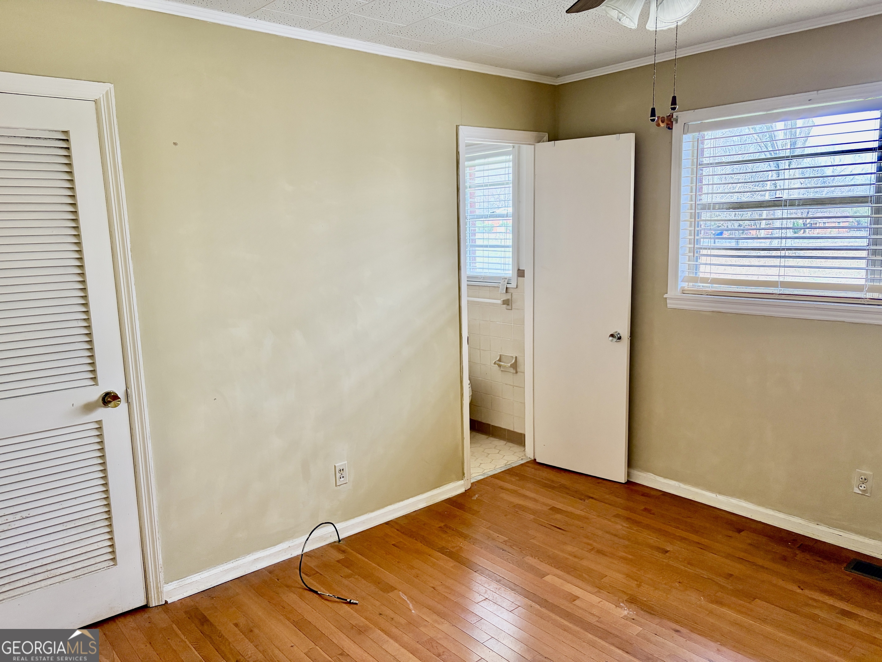 310 McDaniel Station Road Southwest Calhoun, GA 30701 - Photo 11 of 11 a view of an empty room with wooden floor and a window