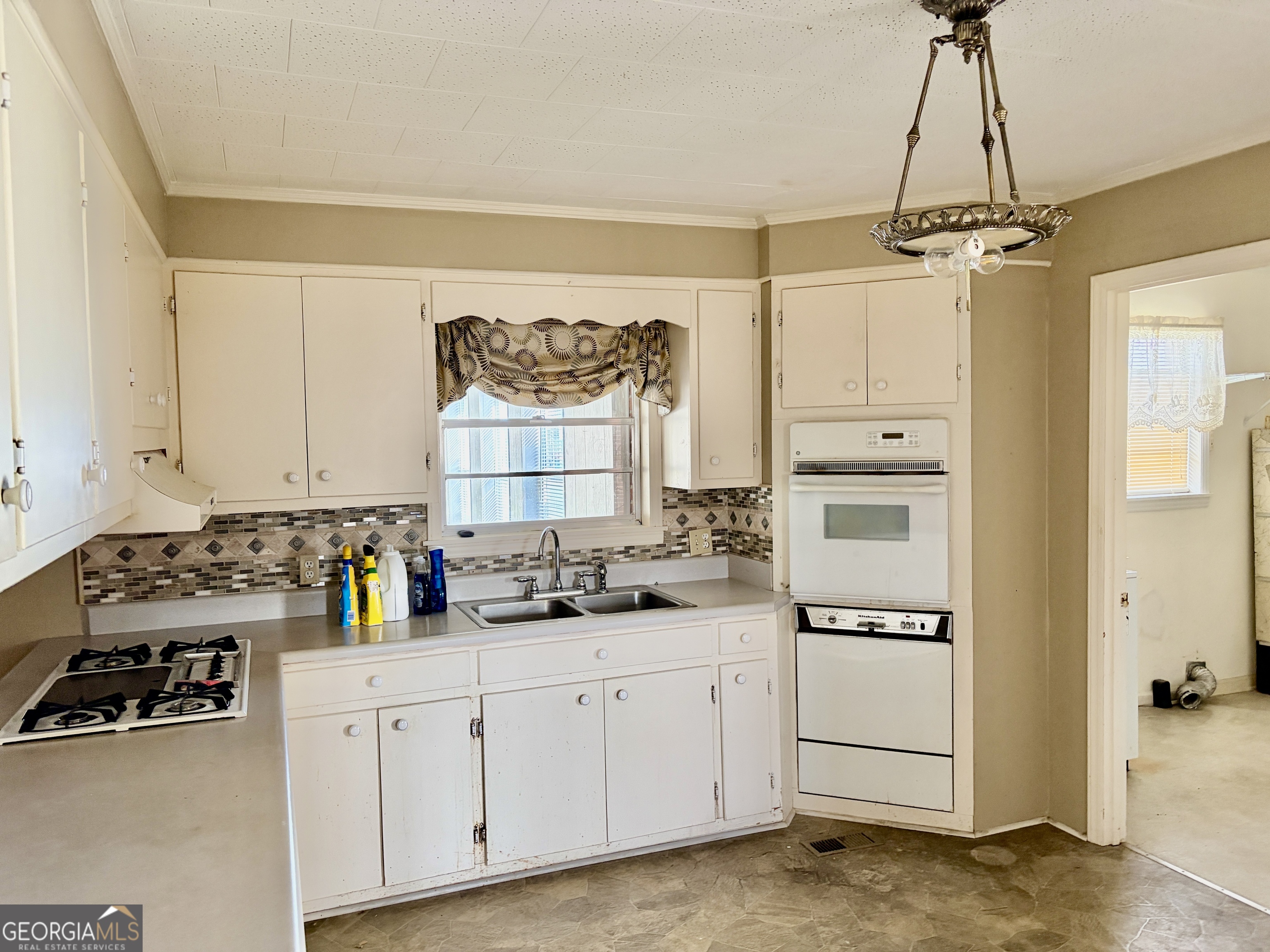 310 McDaniel Station Road Southwest Calhoun, GA 30701 - Photo 4 of 11 a kitchen with stainless steel appliances a sink stove and cabinets