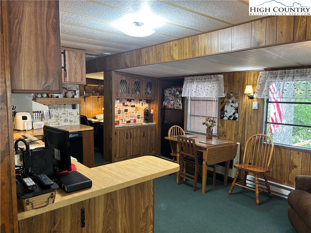 140 Ash Loop Newland, NC 28657 - Photo 12 of 13 a kitchen with stainless steel appliances sink stove dining table and chairs