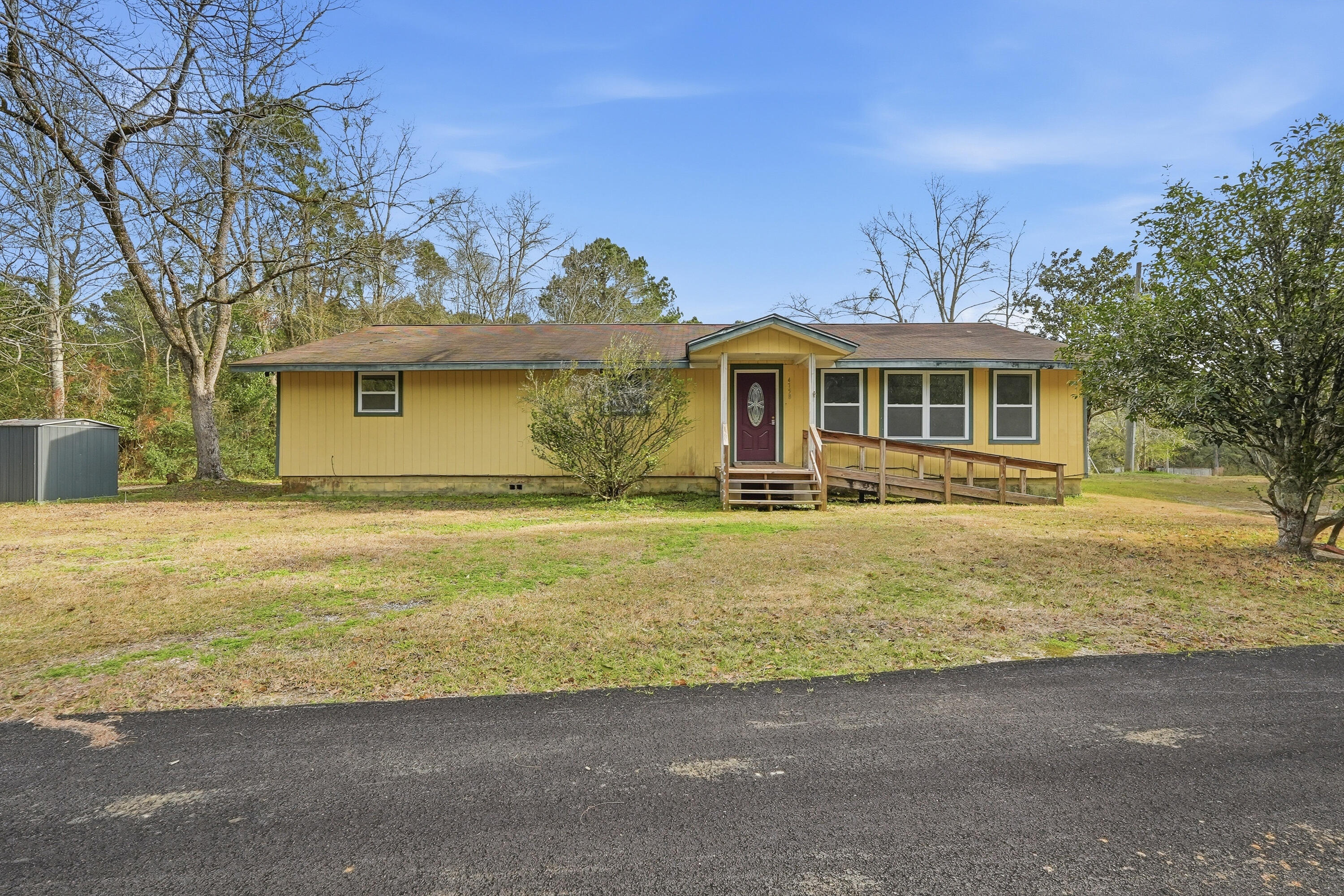 4758 Boutwell Road Laurel Hill, FL 32567 - Photo 1 of 20 a front view of a house with a yard