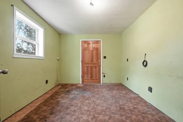 wooden floor in an empty room and a window