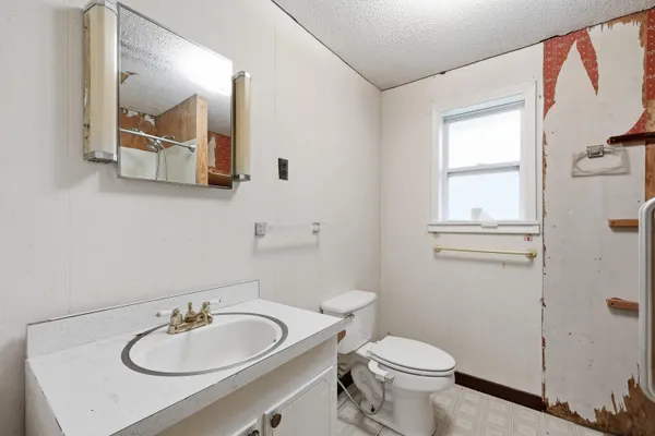 a bathroom with a toilet sink and shower