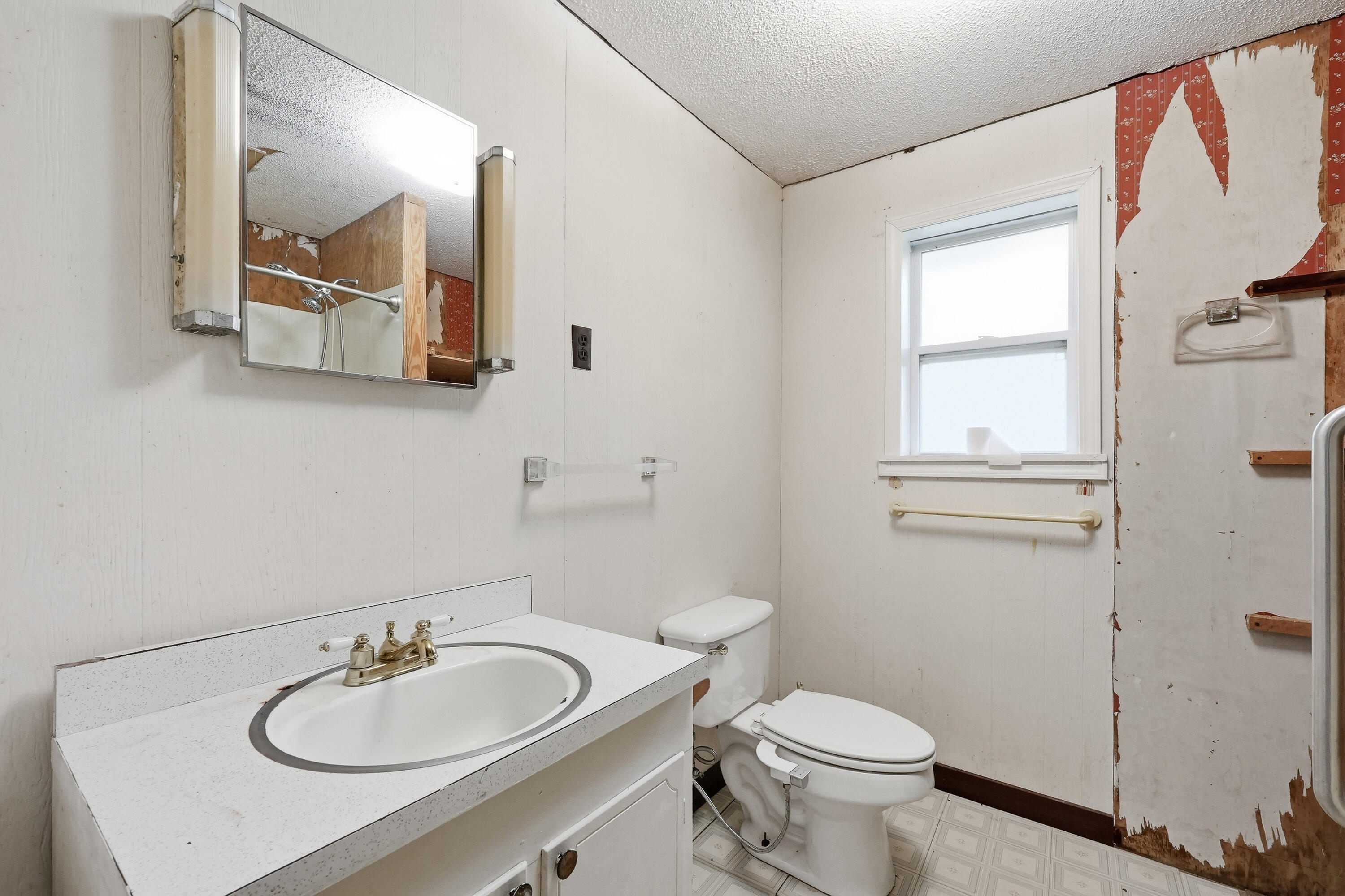 4758 Boutwell Road Laurel Hill, FL 32567 - Photo 14 of 20 a bathroom with a toilet sink and mirror