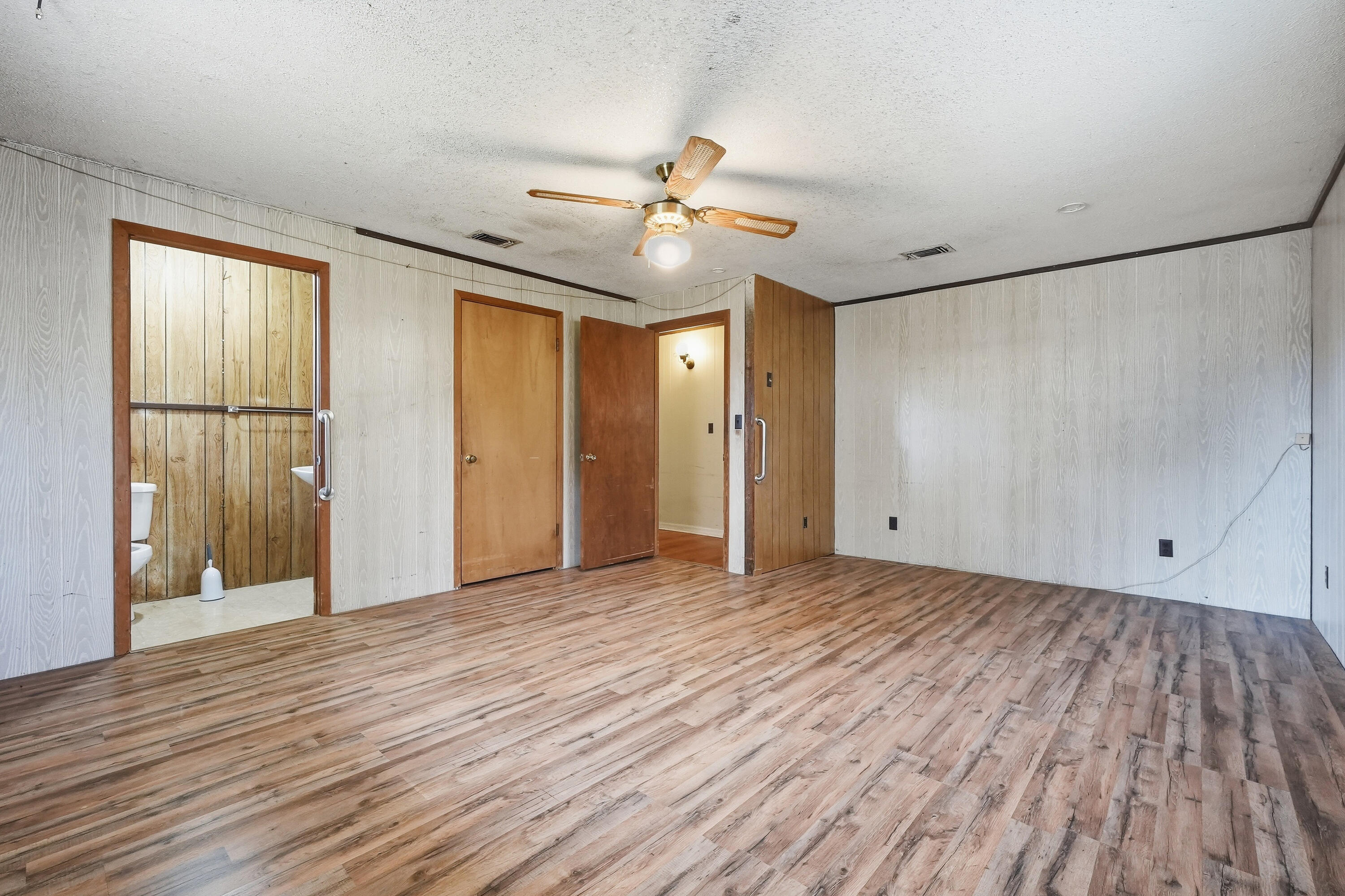 4758 Boutwell Road Laurel Hill, FL 32567 - Photo 17 of 20 wooden floor in an empty room with a window