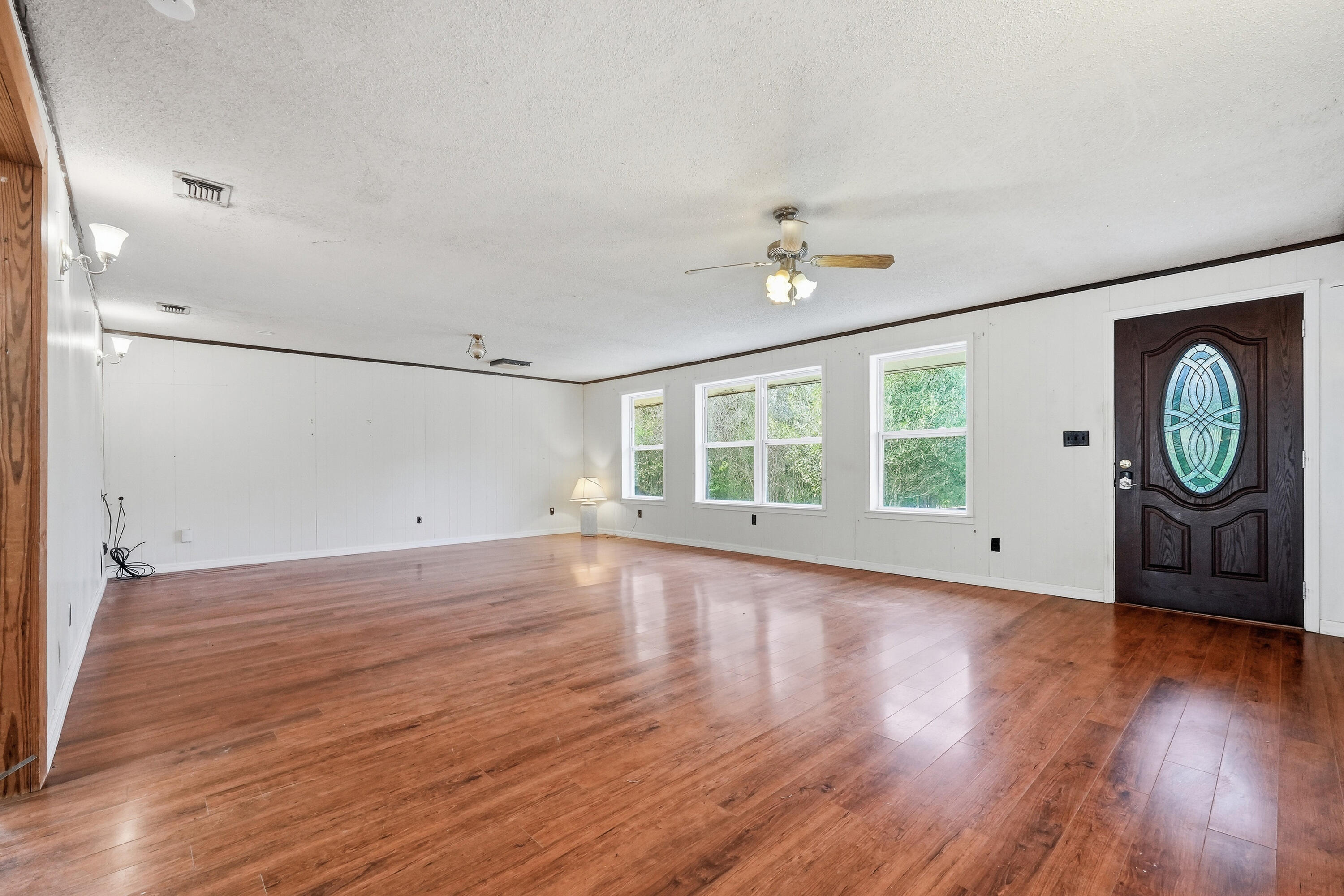 4758 Boutwell Road Laurel Hill, FL 32567 - Photo 3 of 20 wooden floor in an empty room with a window