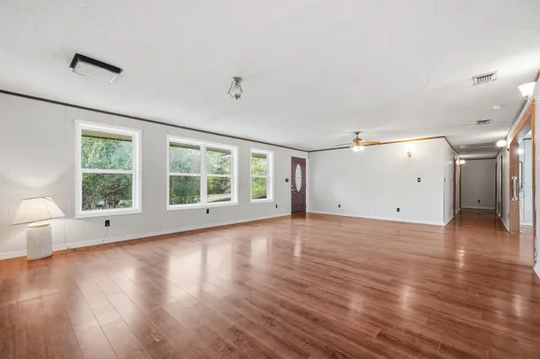 a view of an empty room with wooden floor