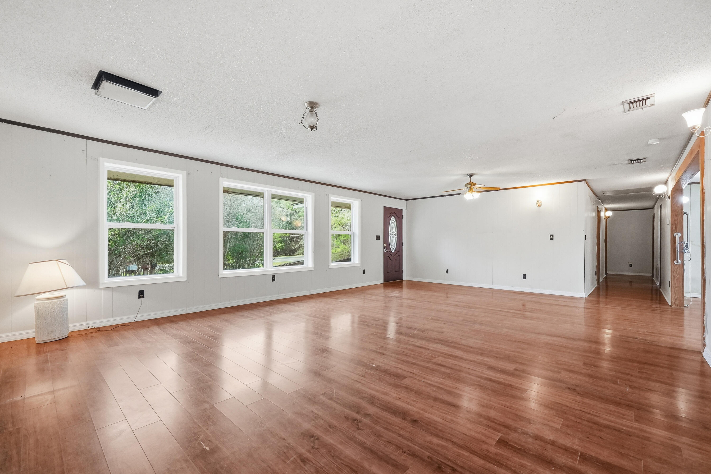 4758 Boutwell Road Laurel Hill, FL 32567 - Photo 5 of 20 a view of an empty room with wooden floor and a window