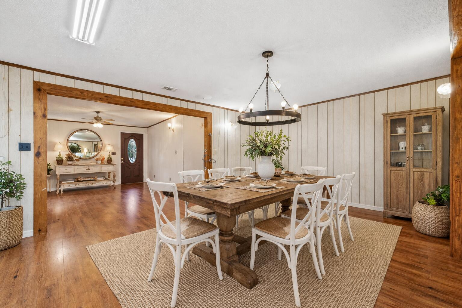 4758 Boutwell Road Laurel Hill, FL 32567 - Photo 7 of 20 a view of a dining room with furniture wooden floor and chandelier