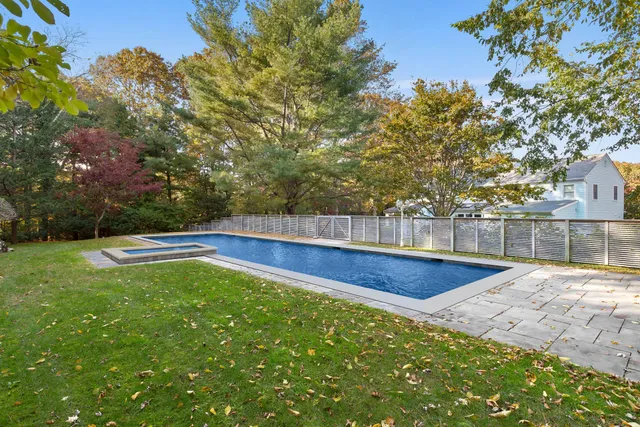 a view of a backyard with large trees