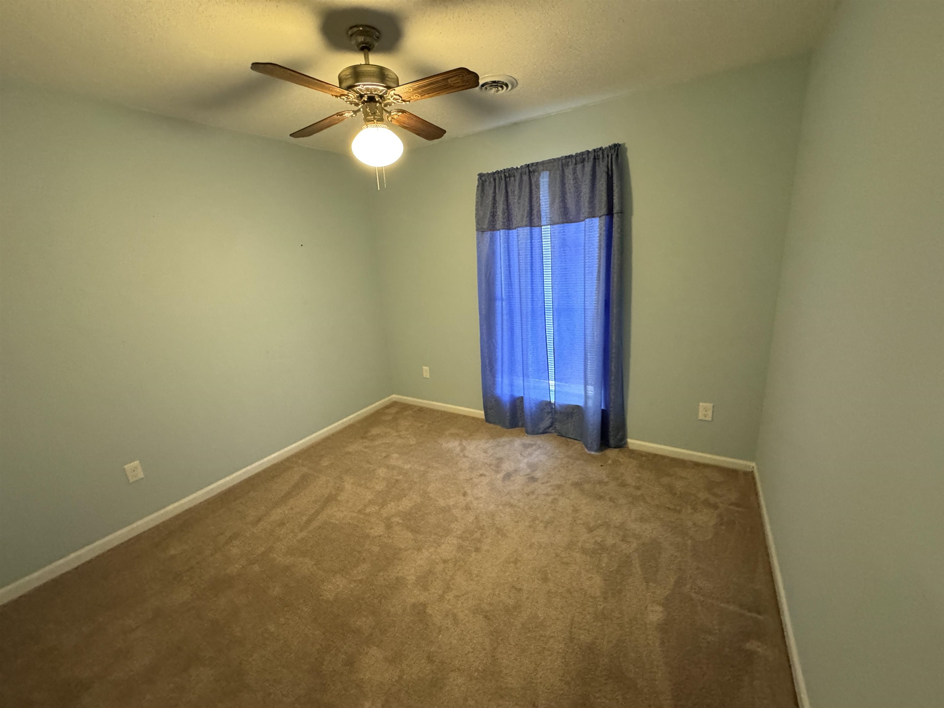 610 Hanna Drive Ripley, TN 38063 - Photo 14 of 23 an empty room with windows and fan