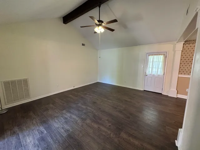 wooden floor in an empty room with a window