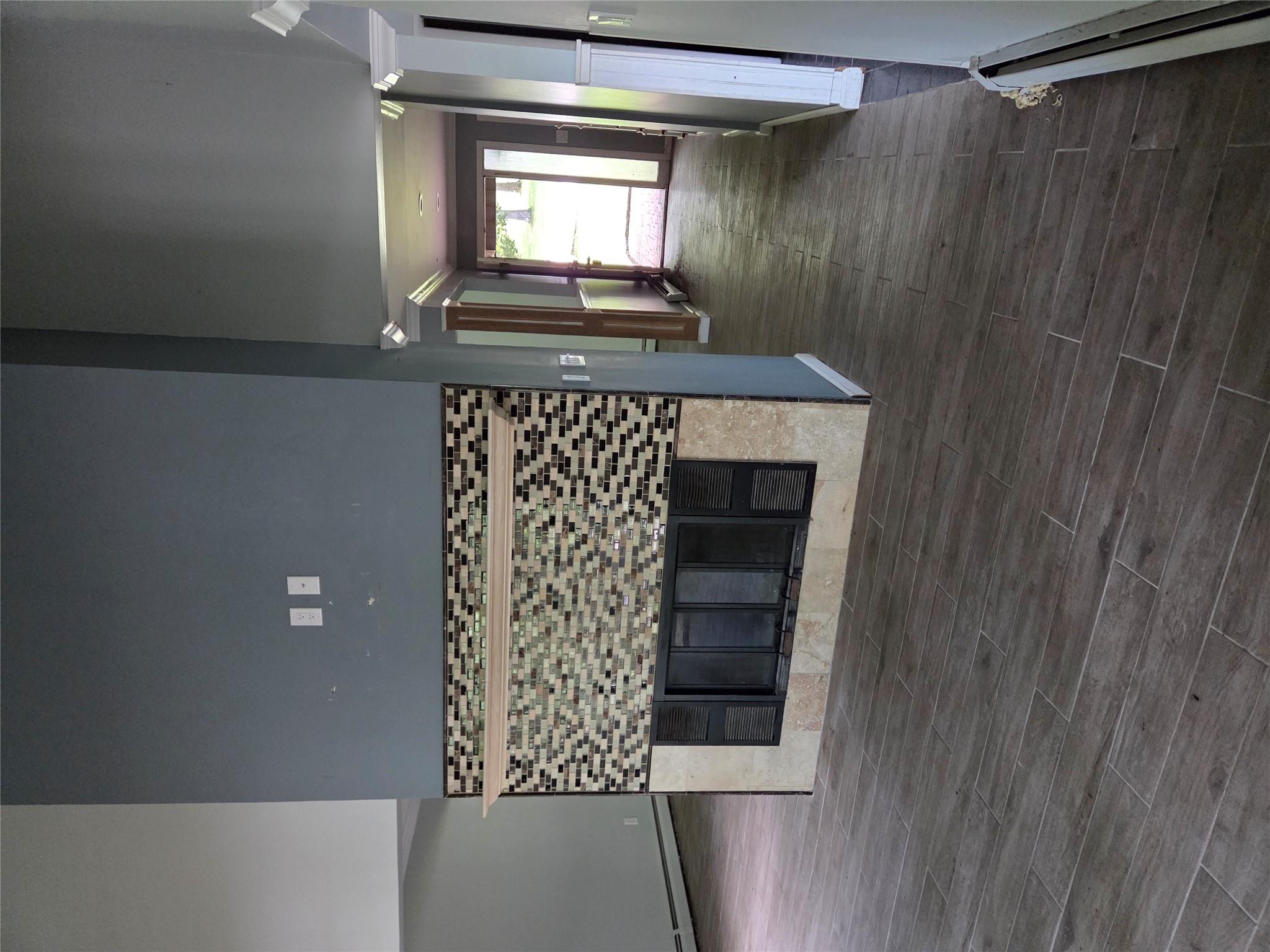 69 Mitchell Road Somers, NY 10589 - Photo 13 of 18 Kitchen with a high ceiling, a tile fireplace, baseboard heating, and dark wood-style floors