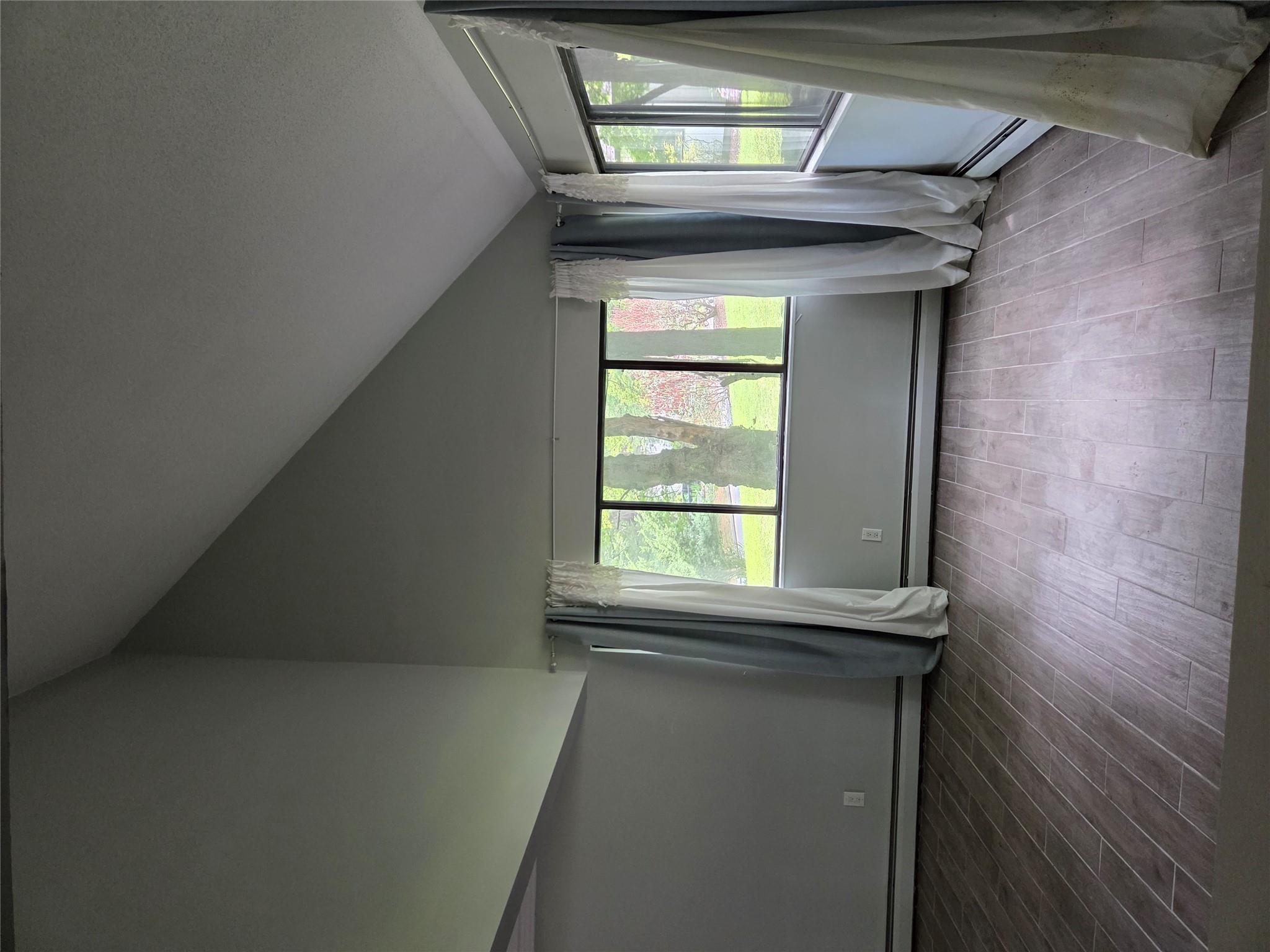 69 Mitchell Road Somers, NY 10589 - Photo 7 of 18 Unfurnished room with a baseboard radiator, vaulted ceiling, healthy amount of natural light, and wood finished floors