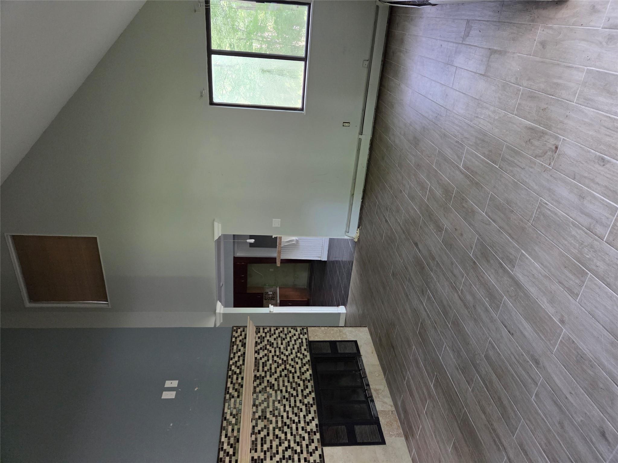 69 Mitchell Road Somers, NY 10589 - Photo 10 of 18 Unfurnished living room with high vaulted ceiling, a fireplace, wood finished floors, and a baseboard heating unit