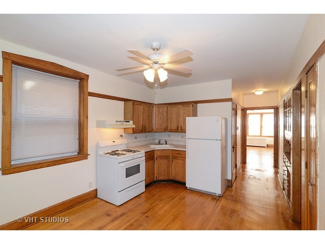 5110 West Roscoe Street Chicago, IL 60641 - Photo 4 of 10 a kitchen with a stove a refrigerator and a sink