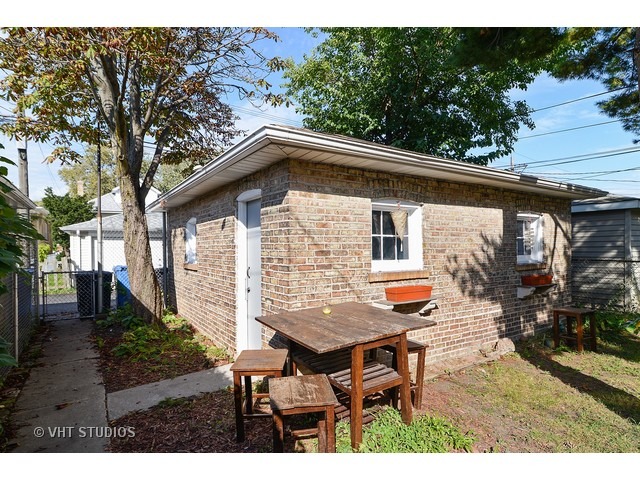 5110 West Roscoe Street Chicago, IL 60641 - Photo 9 of 10 a backyard of a house with table and chairs