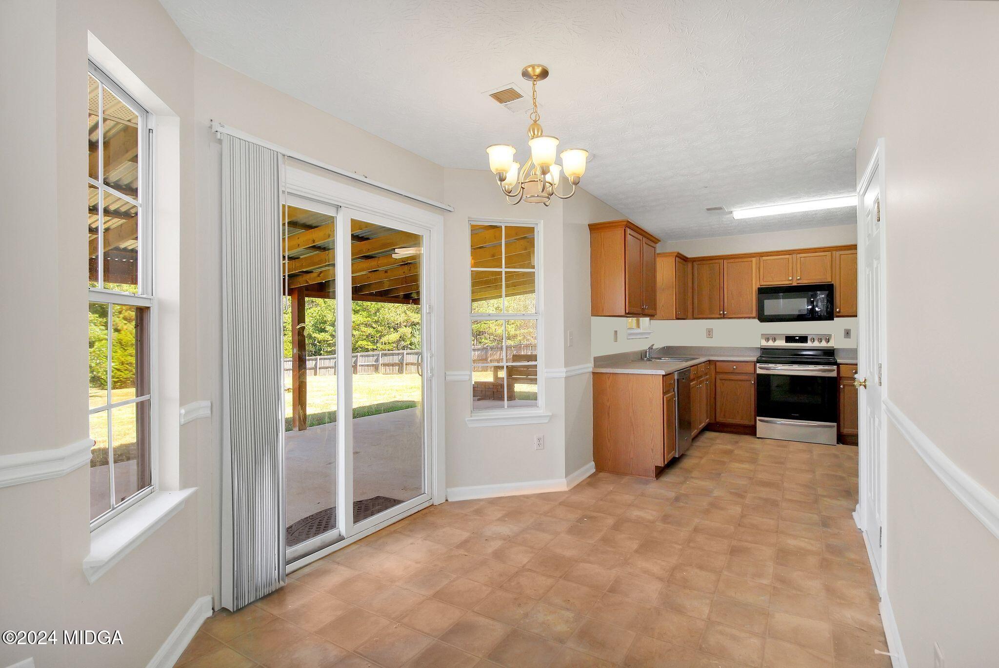 106 Meadow View Drive Jackson, GA 30233 - Photo 14 of 40 a large white kitchen with a large window