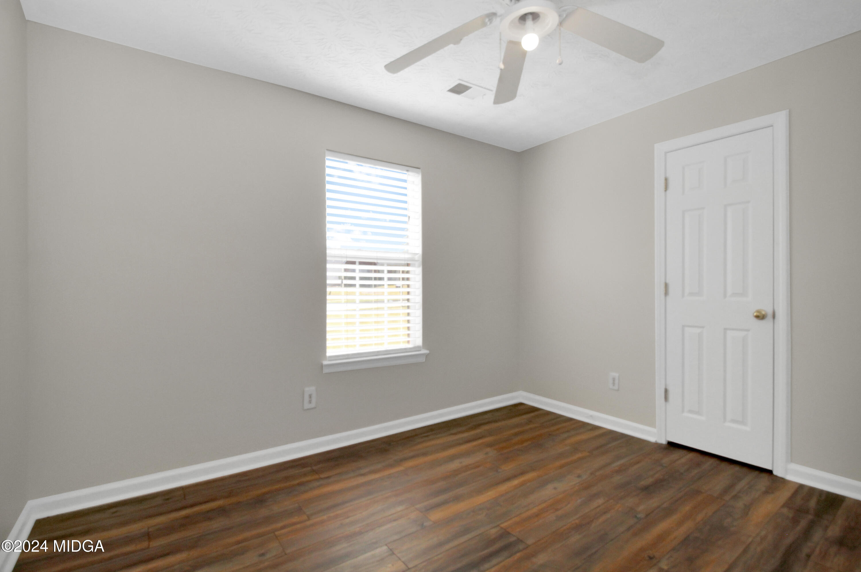 106 Meadow View Drive Jackson, GA 30233 - Photo 15 of 40 an empty room with wooden floor and windows