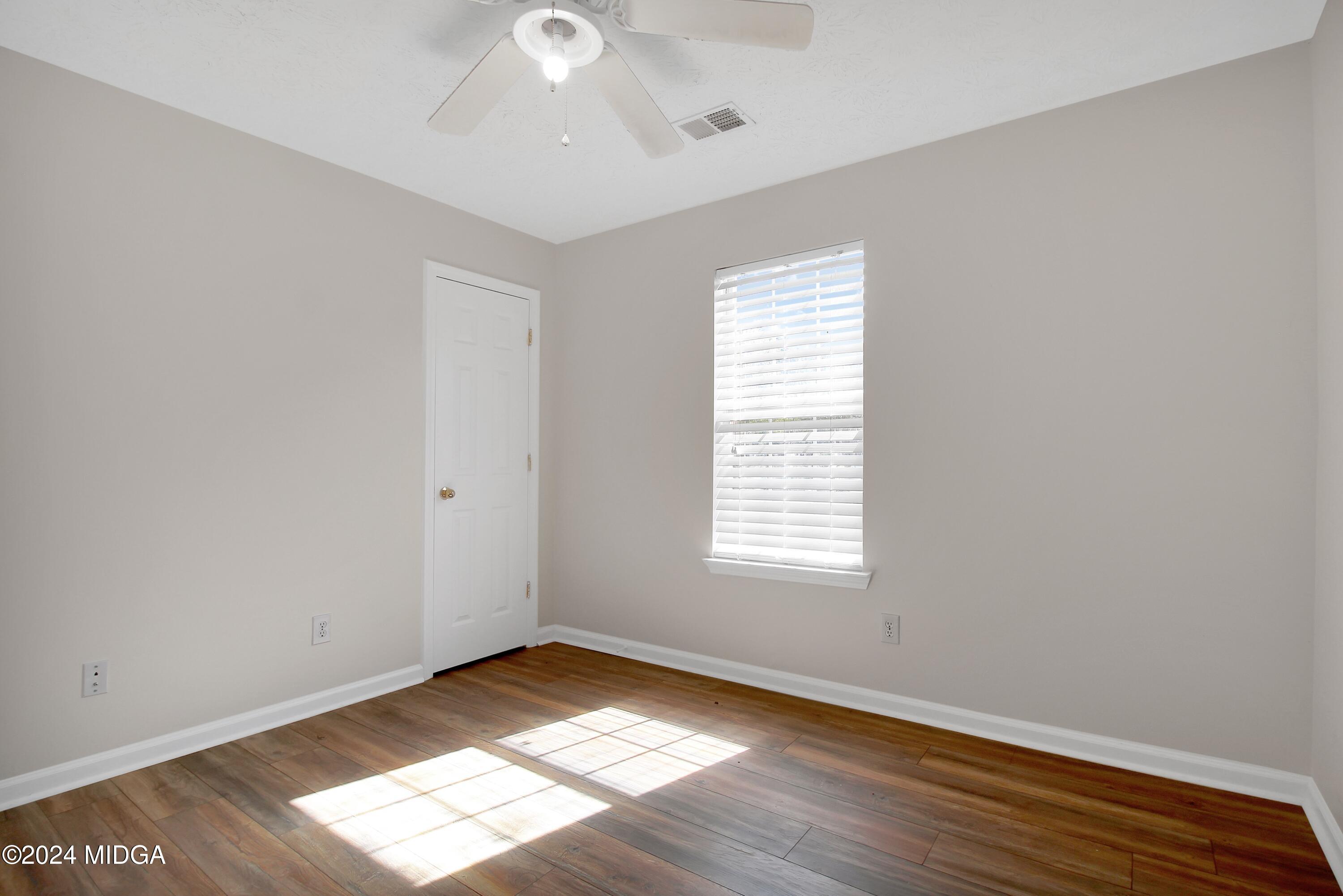 106 Meadow View Drive Jackson, GA 30233 - Photo 16 of 40 a view of an empty room with wooden floor and a window