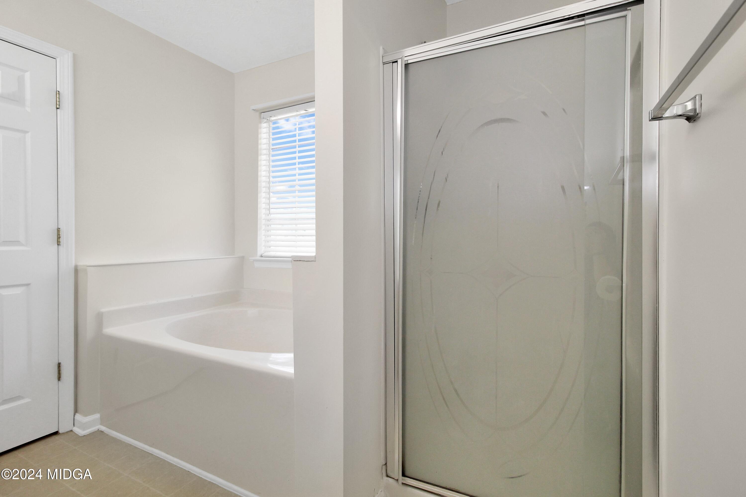 106 Meadow View Drive Jackson, GA 30233 - Photo 20 of 40 a bathroom with a bathtub and a shower