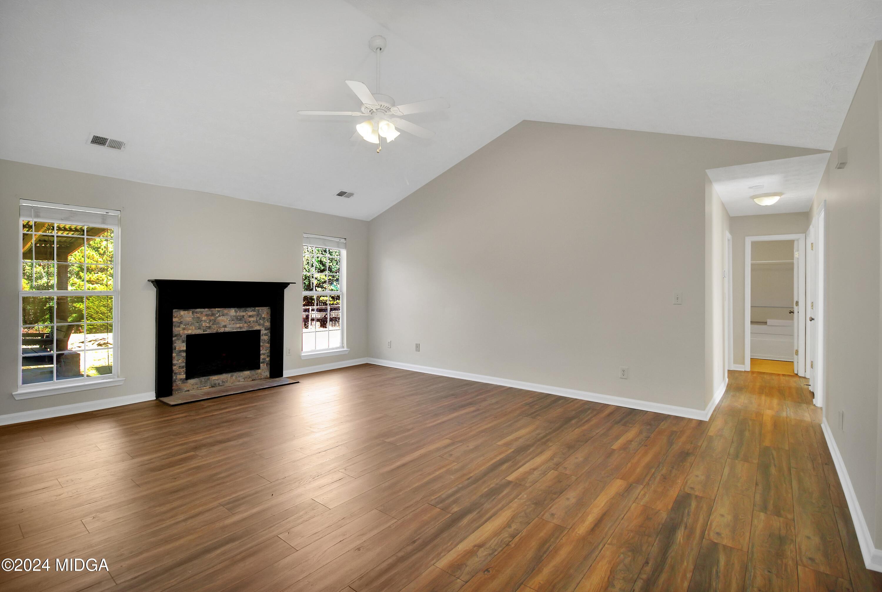 106 Meadow View Drive Jackson, GA 30233 - Photo 2 of 40 a view of an empty room with wooden floor fireplace and a window