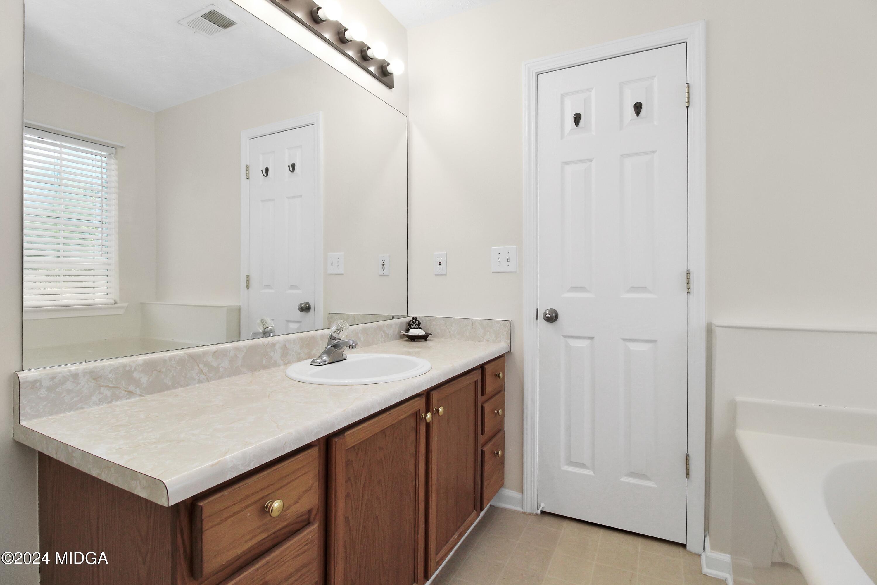 106 Meadow View Drive Jackson, GA 30233 - Photo 22 of 40 a bathroom with a sink and a mirror